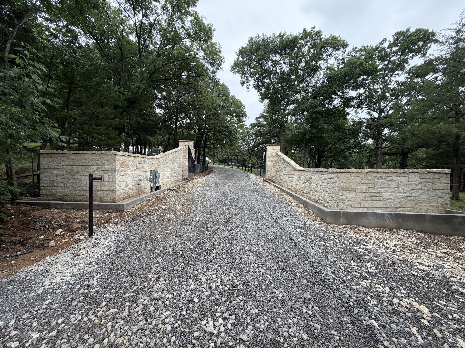 Custom stone estate entrance with iron gates